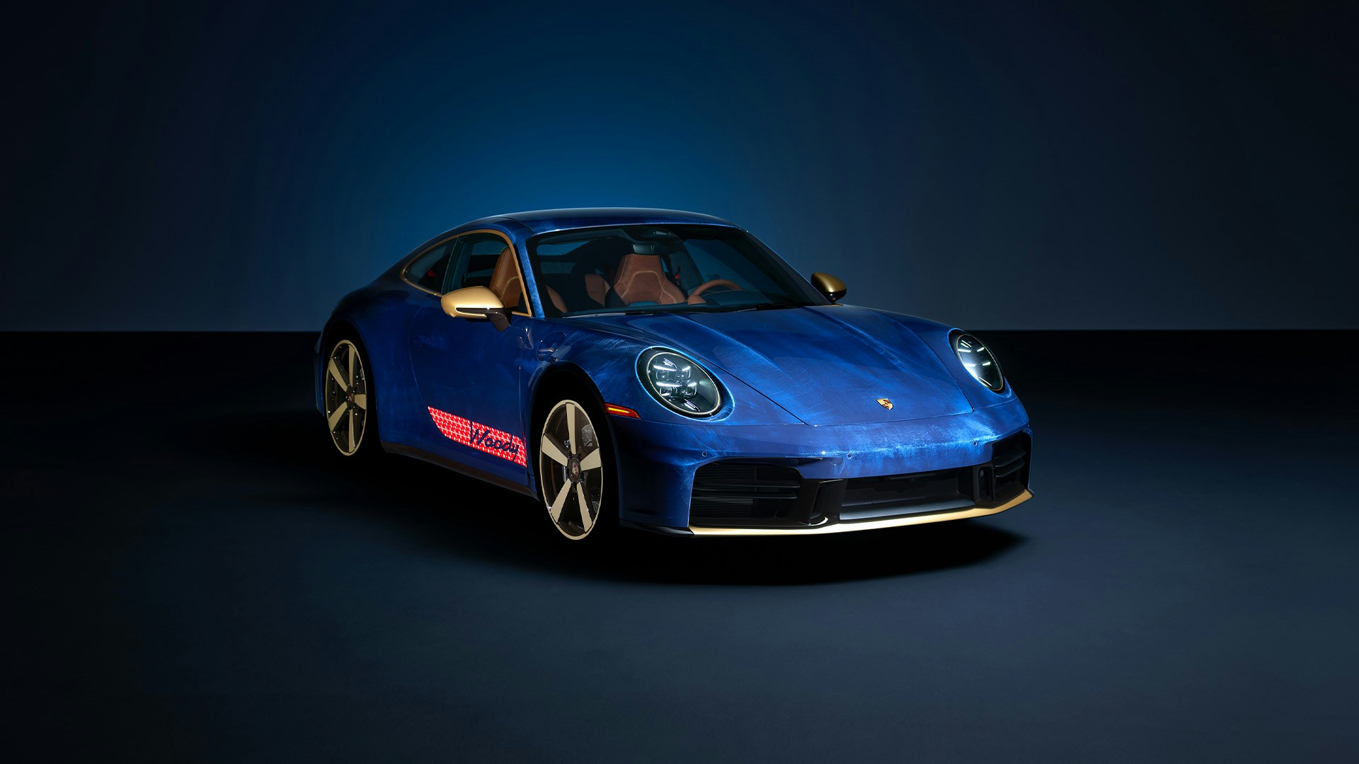 Official Porsche photograph of the Woody 911 Carrera T in a dark studio
